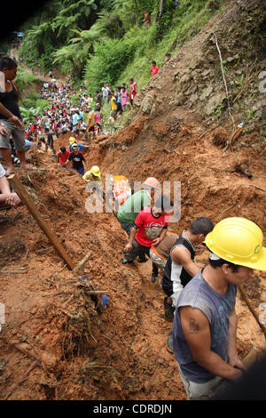 Apr 23, 2011 - Pantukan, Compostella Valley, Philippines - Rescuers search for missing people Saturday after an avalanche of mud buried an illegal gold mining camp on Friday, April 22, 2011 in the town of Pantukan in Compostella Valley in the southern Philippines. Officials say at least three bodies Stock Photo