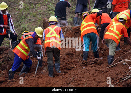 Apr 23, 2011 - Pantukan, Compostella Valley, Philippines - Rescuers search for missing people Saturday after an avalanche of mud buried an illegal gold mining camp on Friday, April 22, 2011 in the town of Pantukan in Compostella Valley in the southern Philippines. Officials say at least three bodies Stock Photo