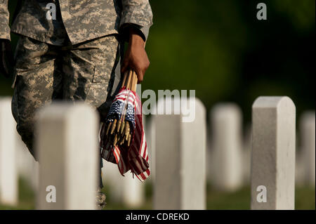 May 26, 2011 - Arlington, Virginia, U.S. - Members of the 3rd U.S. Infantry, known as The Old Guard, place American flags before gravestones and niches of service members buried at Arlington National Cemetery in advance of the Memorial Day weekend. The tradition, known as ''flags in,'' is conducted  Stock Photo