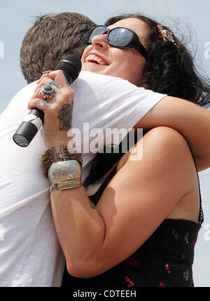 Mike Wolfe, left and Danielle Colby Cushman, two of the three stars on The History Channel's 'American Pickers,' laugh and hug during an appearance Saturday June 4, 2011 at the 'American Pickers' Weekend that brought an estimated 10,000 people to LeClaire, Iowa. Co-star Frank Fritz did not attend th Stock Photo