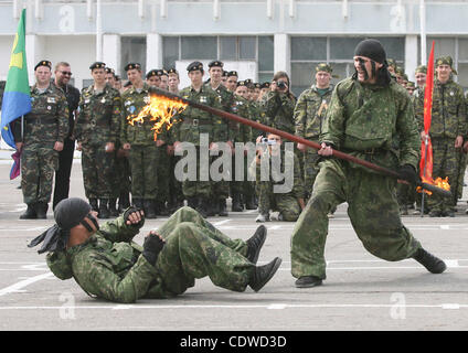 Russian teenagers are getting military skills during the summer training camp Zarnitsa for teenages organized by military-patriotic club.The event is taking place at the military base of 27th Rifle-infantry division near Moscow.Pictured: Spetsnaz unit soldiers demonstrate their skills to children. Stock Photo