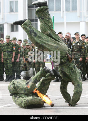 Russian teenagers are getting military skills during the summer training camp Zarnitsa for teenages organized by military-patriotic club.The event is taking place at the military base of 27th Rifle-infantry division near Moscow.Pictured: Spetsnaz unit soldiers demonstrate their skills to children. Stock Photo