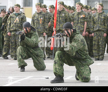 Russian teenagers are getting military skills during the summer training camp Zarnitsa for teenages organized by military-patriotic club.The event is taking place at the military base of 27th Rifle-infantry division near Moscow.Pictured: Spetsnaz unit soldiers demonstrate their skills to children. Stock Photo