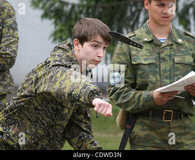 Russian teenagers are getting military skills during the summer training camp Zarnitsa for teenages organized by military-patriotic club.The event is taking place at the military base of 27th Rifle-infantry division near Moscow. Pictured: Russian teenager getting knife throwing skills during militar Stock Photo