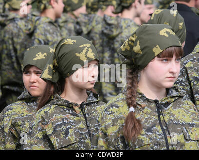 Russian teenagers are getting military skills during the summer training camp Zarnitsa for teenages organized by military-patriotic club.The event is taking place at the military base of 27th Rifle-infantry division near Moscow. Pictured: Russian girls teenagers during military training. Stock Photo