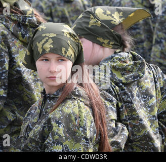 Russian teenagers are getting military skills during the summer training camp Zarnitsa for teenages organized by military-patriotic club.The event is taking place at the military base of 27th Rifle-infantry division near Moscow. Pictured: Russian girls teenagers during military training. Stock Photo