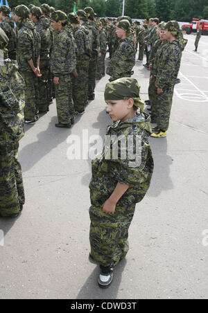 Russian teenagers are getting military skills during the summer training camp Zarnitsa for teenages organized by military-patriotic club.The event is taking place at the military base of 27th Rifle-infantry division near Moscow. Pictured: a little russian boy during military training. Stock Photo