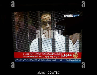 This video image taken from Egyptian State Television shows the sons of Hosni Mubarak stand inside the cage of mesh and iron bars in a Cairo courtroom Wednesday Aug. 3, 2011 as his historic trial began on charges of corruption and ordering the killing of protesters during the uprising that ousted hi Stock Photo