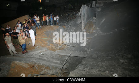 Palestinians inspect the damage at a club following an Israeli air strike in Gaza City, on Aug. 25, 2011. Israeli air strikes killed two Gaza militants, one a local commander of the Islamic Jihad group in the Gaza Strip, and wounded four others who fired rockets at Israel, despite a two-day-old truc Stock Photo