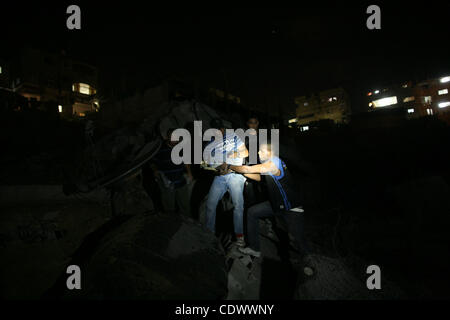 Palestinians inspect the damage at a club following an Israeli air strike in Gaza City, on Aug. 25, 2011. Israeli air strikes killed two Gaza militants, one a local commander of the Islamic Jihad group in the Gaza Strip, and wounded four others who fired rockets at Israel, despite a two-day-old truc Stock Photo