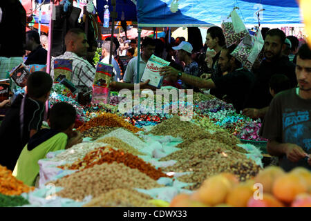 Aug. 29, 2011 - Gaza City, Gaza Strip - Palestinian vendors display their goods for sale during preparations for Eid al-Fitr at the main market, in Gaza city. Muslims throughout the world buy clothes, sweets and other popular items to prepare for The Eid aL-Fitr ,the festivities marking the end of t Stock Photo