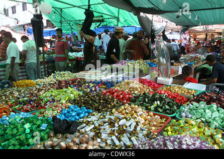 Aug. 29, 2011 - Gaza City, Gaza Strip - Palestinian vendors display their goods for sale during preparations for Eid al-Fitr at the main market, in Gaza city. Muslims throughout the world buy clothes, sweets and other popular items to prepare for The Eid aL-Fitr ,the festivities marking the end of t Stock Photo