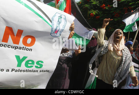 Palestinian women chant slogans and wave their national flag during a demonstration in support of Palestinian leader Mahmud Abbas' bid for statehood recognition at the United Nations on September 22, 2011 in Gaza City. Photo by Ashraf Amra Stock Photo