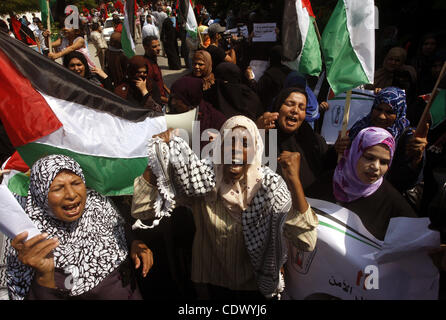 Palestinian women chant slogans and wave their national flag during a demonstration in support of Palestinian leader Mahmud Abbas' bid for statehood recognition at the United Nations on September 22, 2011 in Gaza City.  Photo by Mahmud Nassar Stock Photo