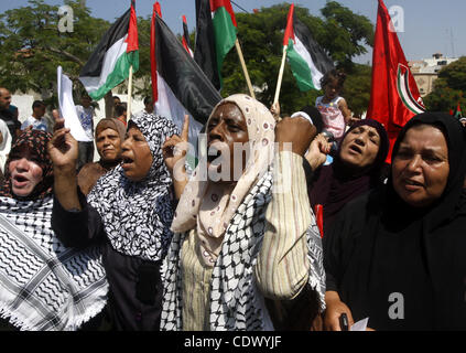 Palestinian women chant slogans and wave their national flag during a demonstration in support of Palestinian leader Mahmud Abbas' bid for statehood recognition at the United Nations on September 22, 2011 in Gaza City.  Photo by Mahmud Nassar Stock Photo