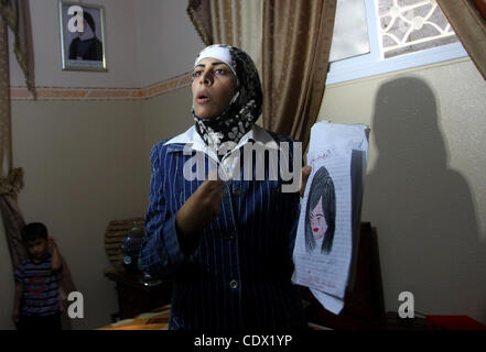 Oct. 19, 2011 - Gaza City, Gaza Strip, Palestinian Territory - Freed Palestinian prisoner Wafa Albes displays her drawings for her relatives after her release from an Israeli jail on October 19, 2011 in the Jabalia refugee camp. Wafa has been jailed in Israel since 2005. The Palestinian Hamas moveme Stock Photo
