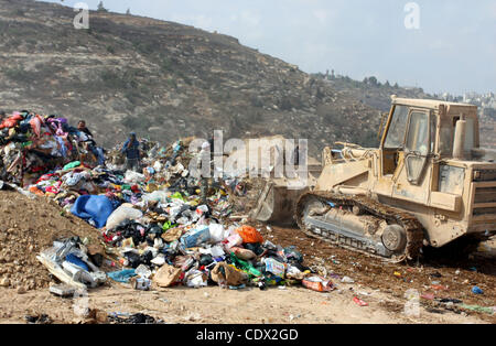 Oct. 28, 2011 - Ramallah, West Bank, Palestinian Territory - Palestinians sift through garbage that was dumped near Ramallah, in the West Bank, 27 October 2011. Palestinians regularly sift through the garbage looking for clothes, metal and any other object thrown out by the nearby Jewish settlements Stock Photo