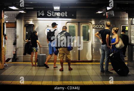 Aug. 27, 2011 - Manhattan, New York, U.S. - Riders board a C line train at the 14th Street subway station as the MTA systematically begins shutting down subway and bus service at noon as Hurricane Irene heads for New York. (Credit Image: © Bryan Smith/ZUMAPRESS.com) Stock Photo