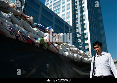 Oct. 31, 2011 - Bangkok, Bangkok, Thailand - Office worker passes by the wall of sandbags placed in front of the offices in inner Bangkok. Monday is the first day after Thai prime minister declared long weekend for all workers in anticipation of further inundation of parts of Bangkok. .Thai prime mi Stock Photo