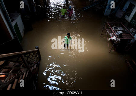 Oct. 31, 2011 - Bangkok, Thailand - A worker walks through a flooded warehouse in Chinatown, where most of the small businesses remain open despite the high waters. The capital's financial district and parts of inner Bangkok were spared from the floodwaters. (Credit Image: © Agron Dragaj/ZUMAPRESS.c Stock Photo