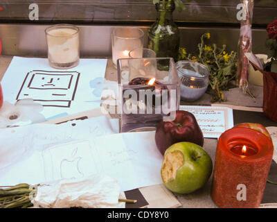 The Apple Store at 679 N. Michigan Avenue becomes a memorial shrine.  People mourning Steve Jobs recent death show their grief by leaving flowers, lit candles, and by attaching personal messages in colorful post-it notes to the window of the store.  The messages are in multiple languages.  People ha Stock Photo