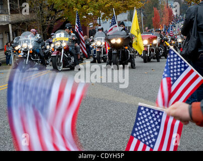 Nov. 11, 2011 - Roseburg, Oregon, U.S - Children wave flags as members of the Patriot Guard ride past during the annual Veterans Day Parade in downtown Roseburg. The parade is billed as the second largest Veterans Day Parade in Oregon. Veterans Day, formally  Armistice Day, is an annual holiday hono Stock Photo