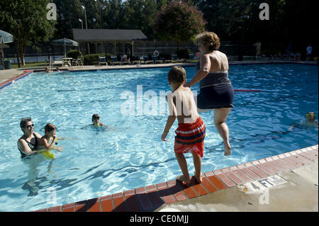 Aug. 27, 2011 - Marietta, GA - Jennifer Schwenker runs toward a community swimming pool with her 8-year-old son Ben, who is autistic. (Credit Image: © Robin Nelson/ZUMAPRESS.com) Stock Photo
