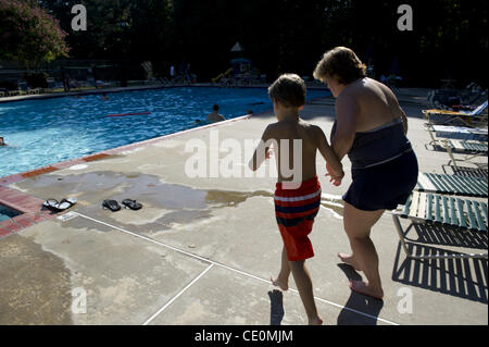 Aug. 27, 2011 - Marietta, GA - Jennifer Schwenker runs toward a community swimming pool with her 8-year-old son Ben, who is autistic. (Credit Image: © Robin Nelson/ZUMAPRESS.com) Stock Photo