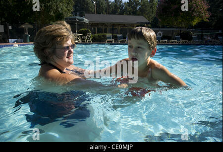 Aug. 27, 2011 - Marietta, GA - Jennifer Schwenker with son Ben, 8 in a community swimming pool. Ben and twin brother Sam are both autistic with limited verbal skills. (Credit Image: © Robin Nelson/ZUMAPRESS.com) Stock Photo