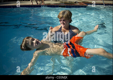 Aug. 27, 2011 - Marietta, GA - Jennifer Schwenker with son Ben, 8 in a community swimming pool. Ben and twin brother Sam are both autistic with limited verbal skills. They are practicing ''Starfish' in the pool, an exercise that helps him to be comfortable in the pool. (Credit Image: © Robin Nelson/ Stock Photo