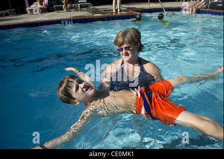 Aug. 27, 2011 - Marietta, GA - Jennifer Schwenker with son Ben, 8 in a community swimming pool. Ben and twin brother Sam are both autistic with limited verbal skills. They are practicing ''Starfish' in the pool, an exercise that helps him to be comfortable in the pool. (Credit Image: © Robin Nelson/ Stock Photo