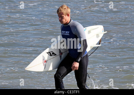 Trevor Donovan Cast members of the television show '90210' film a beach scene with wetsuits and surfboards in Malibu. Los Angeles, California - 22.11.10 Stock Photo