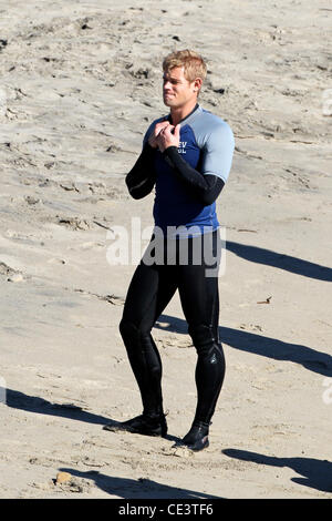 Trevor Donovan Cast members of the television show '90210' film a beach scene with wetsuits and surfboards in Malibu. Los Angeles, California - 22.11.10 Stock Photo