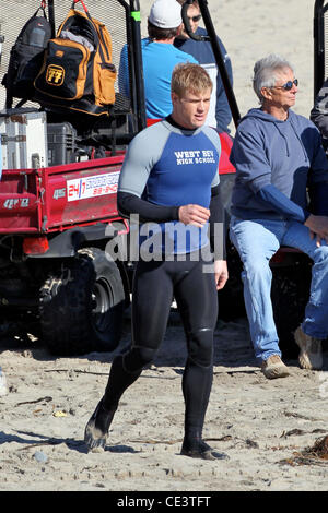 Trevor Donovan Cast members of the television show '90210' film a beach scene with wetsuits and surfboards in Malibu. Los Angeles, California - 22.11.10 Stock Photo