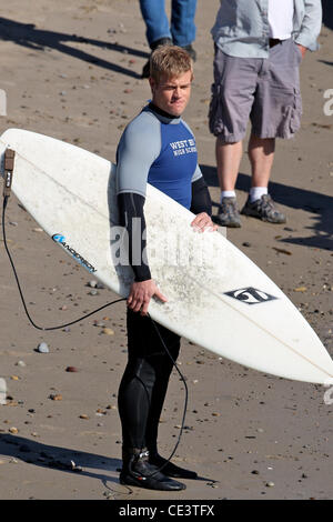 Trevor Donovan Cast members of the television show '90210' film a beach scene with wetsuits and surfboards in Malibu. Los Angeles, California - 22.11.10 Stock Photo