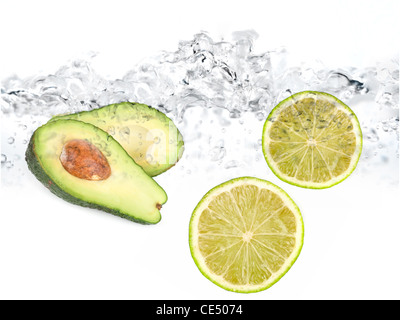 Green limes and avocado in water dropped isolated on a white Stock Photo