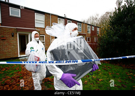 Scene Of Crime Officers remove a computer from a crime scene. Picture by James Boardman. Stock Photo