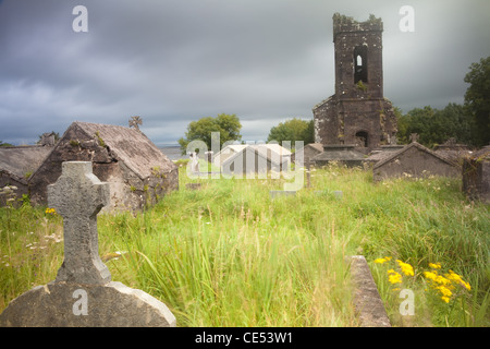 Old desolated cemetery overgrown with grass and wildflowers long exposure gives moody romantic feel Stock Photo