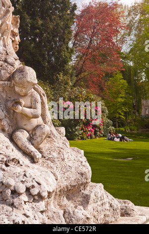 People enjoying the afternoon sun in the jardin des prebendes d'oe in Tours, France. Stock Photo