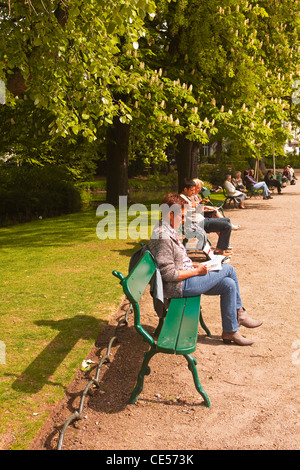 People enjoying the afternoon sun in the jardin des prebendes d'oe in Tours, France. Stock Photo