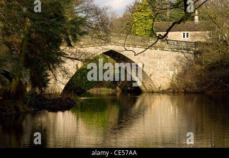 Froggatt Bridge is a stone structure spanning the river Derwent at the village of Froggatt in the Derbyshire Peak District Stock Photo