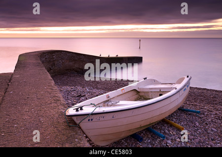 Fishing boat on Sidmouth beach at dawn, Sidmouth, Devon, England. Winter (January) 2012.