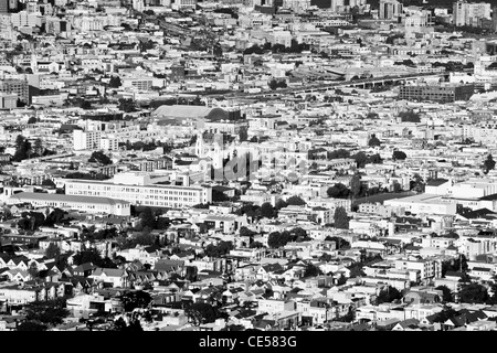 black and white photograph of San Francisco outskirts, showing the tightly-packed urban sprawl of buildings, streets and trees.
