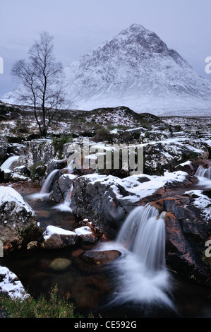 Waterfall on the River Coupall with Buachaille Etive Mor in the background. Winter view in Glencoe, Scottish Highlands Stock Photo