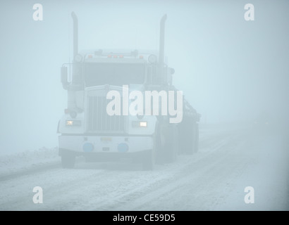 White eighteen wheeler truck in snow blizzard, Alaska, US Stock Photo