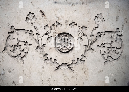 Ornament with botanical motives on an old sandstone wall Stock Photo