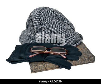 Tweed hat with black gloves and glasses on a book - path included Stock Photo