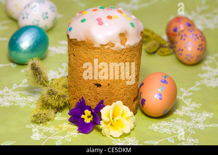 Easter cake with glace icing and colored easter eggs Stock Photo