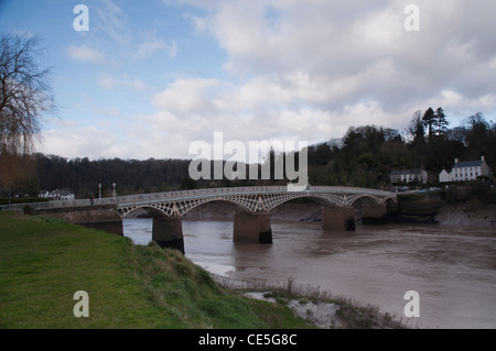 Old cast iron bridge over River Wye at Chepstow on cloudy day Stock Photo