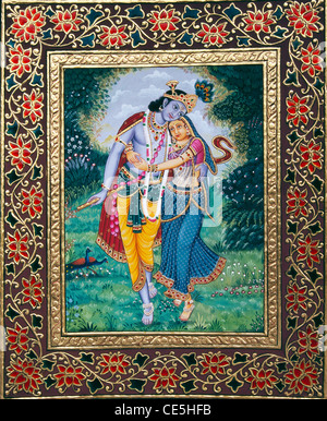 Radha Krishna dancing in garden gold embossed mount border miniature painting on paper Stock Photo